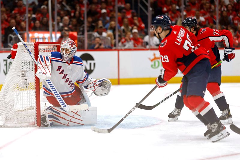 Apr 26, 2024; Washington, District of Columbia, USA; New York Rangers goaltender Igor Shesterkin (31) makes a save on Washington Capitals center Hendrix Lapierre (29) in the third period in game three of the first round of the 2024 Stanley Cup Playoffs at Capital One Arena. Mandatory Credit: Geoff Burke-USA TODAY Sports