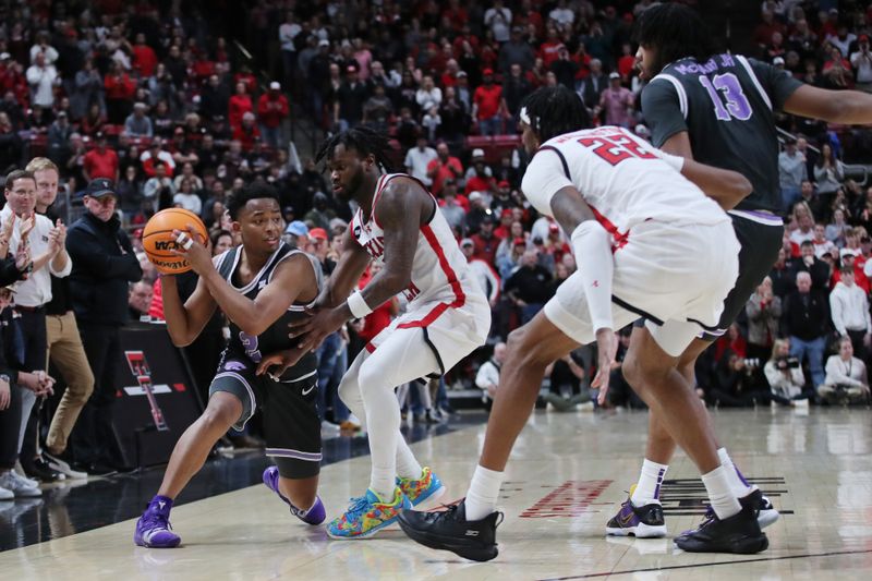 Jan 13, 2024; Lubbock, Texas, USA;  Kansas State Wildcats guard Tylor Perry (2) keeps the ball from Texas Tech Red Raiders guard Joe Toussaint (6) in the second half at United Supermarkets Arena. Mandatory Credit: Michael C. Johnson-USA TODAY Sports