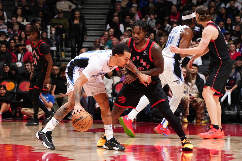 TORONTO, CANADA - JANUARY 3: Davion Mitchell #45 of the Toronto Raptors plays defense during the game against the Orlando Magic on January 3, 2025 at the Scotiabank Arena in Toronto, Ontario, Canada.  NOTE TO USER: User expressly acknowledges and agrees that, by downloading and or using this Photograph, user is consenting to the terms and conditions of the Getty Images License Agreement.  Mandatory Copyright Notice: Copyright 2025 NBAE(Photo by Mark Blinch/NBAE via Getty Images)