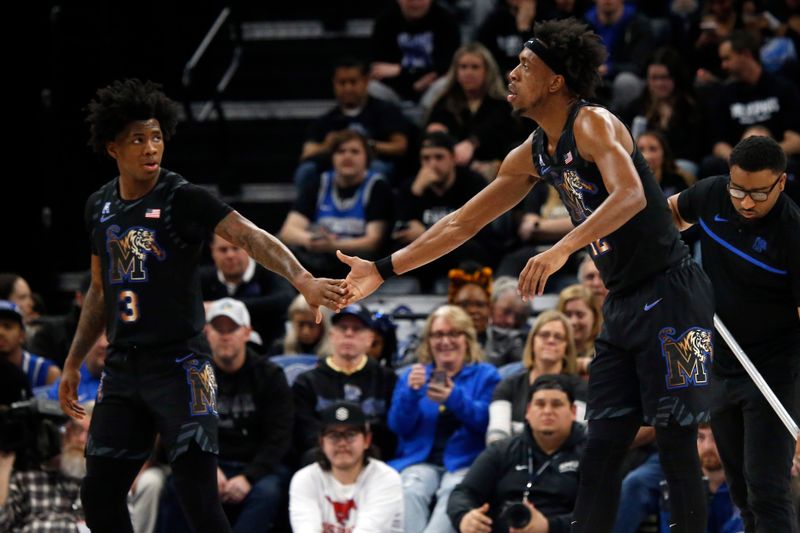 Jan 26, 2023; Memphis, Tennessee, USA; Memphis Tigers guard Kendric Davis (3) checks on Memphis Tigers forward DeAndre Williams (12) after a fall during the first half against the Southern Methodist Mustangs at FedExForum. Mandatory Credit: Petre Thomas-USA TODAY Sports