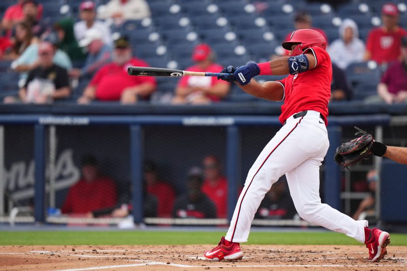 Mar 4, 2025; West Palm Beach, Florida, USA; Washington Nationals outfielder Amed Rosario (13) hits a single against the St. Louis Cardinals during the third inning at CACTI Park of the Palm Beaches. Mandatory Credit: Rich Storry-Imagn Images