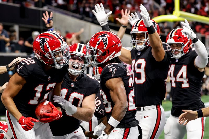 Atlanta Falcons wide receiver KhaDarel Hodge (12) celebrates his touchdown off a New Orleans Saints fumble during the first half of an NFL football game, Sunday, Sept. 29, 2024, in Atlanta. (AP Photo/Butch Dill)