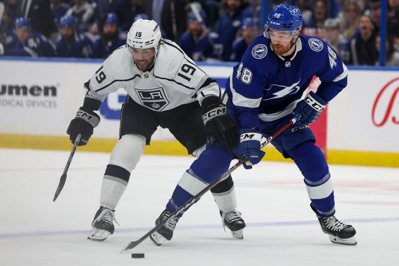 Jan 28, 2023; Tampa, Florida, USA;  Los Angeles Kings left wing Alex Iafallo (19) and Tampa Bay Lightning defenseman Nick Perbix (48) battle for the puck in the second period at Amalie Arena. Mandatory Credit: Nathan Ray Seebeck-USA TODAY Sports