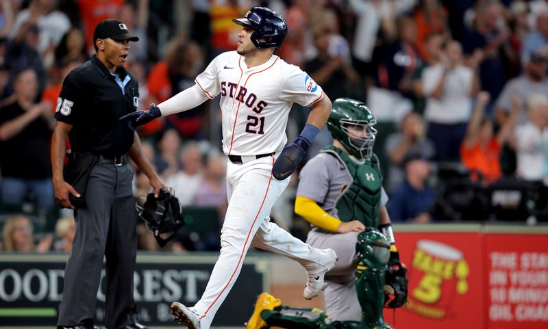 Sep 12, 2024; Houston, Texas, USA; Houston Astros catcher Yainer Diaz (21) crosses home plate to score a run against the Oakland Athletics during the eighth inning at Minute Maid Park. Mandatory Credit: Erik Williams-Imagn Images