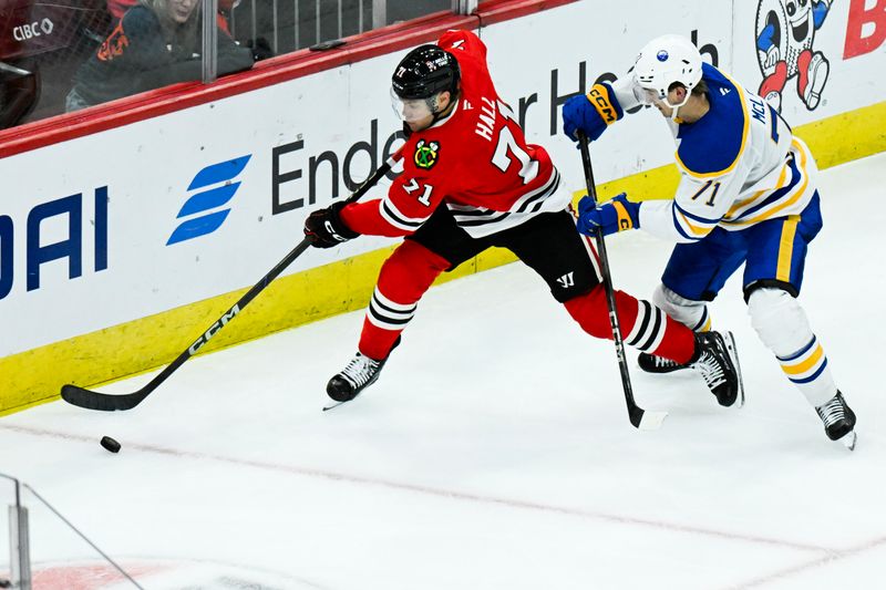 Oct 19, 2024; Chicago, Illinois, USA;  Chicago Blackhawks left wing Taylor Hall (71) and Buffalo Sabres center Ryan McLeod (71) fight for the puck during the third period at the United Center. Mandatory Credit: Matt Marton-Imagn Images