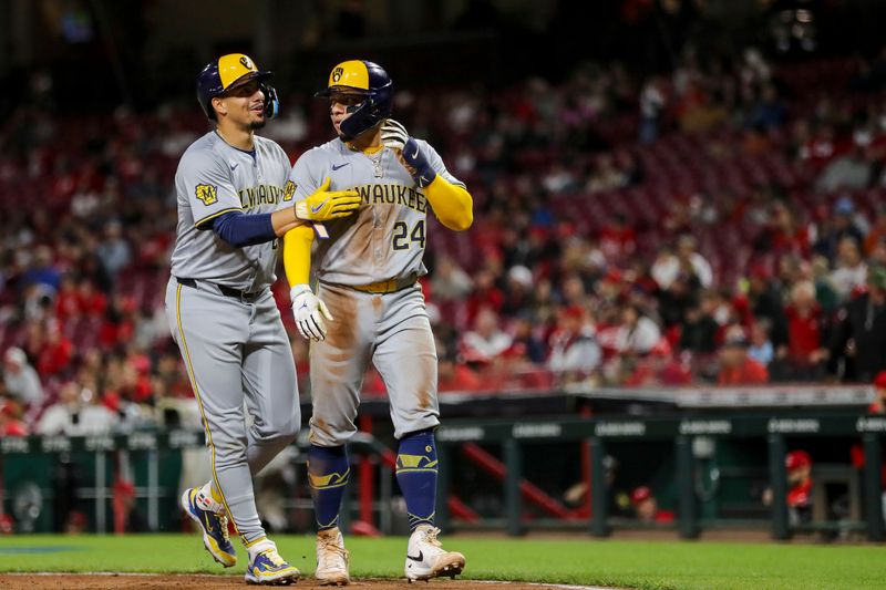 Apr 9, 2024; Cincinnati, Ohio, USA; Milwaukee Brewers shortstop Willy Adames (27) reacts with catcher William Contreras (24) after scoring on a two-run double hit by first baseman Jake Bauers (not pictured) in the seventh inning against the Cincinnati Reds at Great American Ball Park. Mandatory Credit: Katie Stratman-USA TODAY Sports