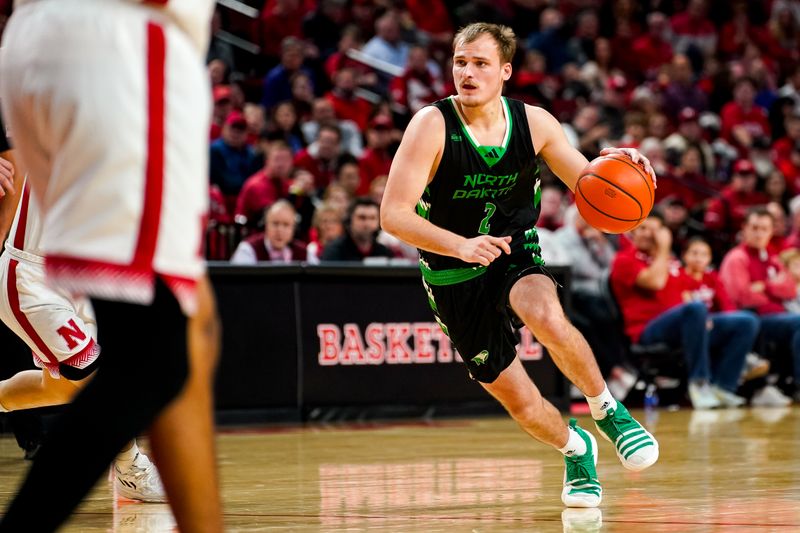 Dec 20, 2023; Lincoln, Nebraska, USA; North Dakota Fighting Hawks guard Eli King (2) dribbles the ball against the Nebraska Cornhuskers during the second half at Pinnacle Bank Arena. Mandatory Credit: Dylan Widger-USA TODAY Sports