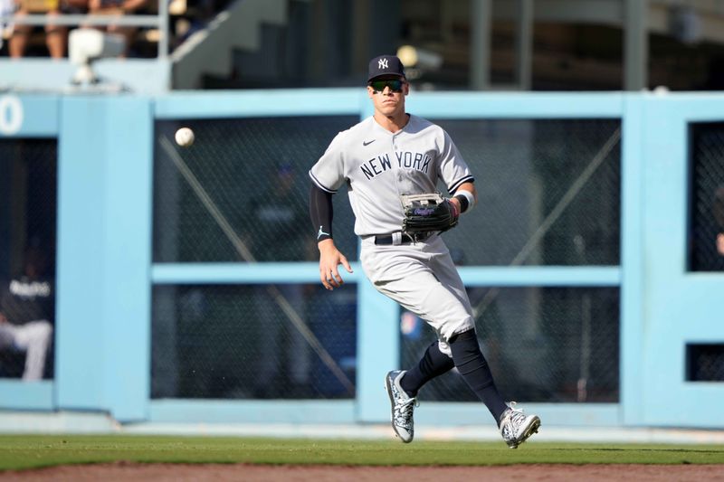 Jun 3, 2023; Los Angeles, California, USA; New York Yankees right fielder Aaron Judge (99) fields the ball on a single by Los Angeles Dodgers catcher Will Smith (not pictured) in the fourth inning at Dodger Stadium. Mandatory Credit: Kirby Lee-USA TODAY Sports