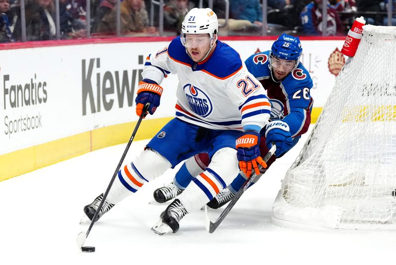 Apr 18, 2024; Denver, Colorado, USA; Edmonton Oilers left wing Adam Erne (21) and Colorado Avalanche left wing Miles Wood (28) battle for the puck in the third period at Ball Arena. Mandatory Credit: Ron Chenoy-USA TODAY Sports