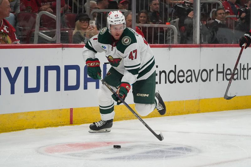 Oct 4, 2024; Chicago, Illinois, USA; Minnesota Wild defenseman Declan Chisholm (47) plays against the Chicago Blackhawks during the first period at United Center. Mandatory Credit: David Banks-Imagn Images