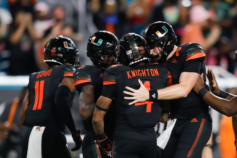 Oct 23, 2021; Miami Gardens, Florida, USA; Miami Hurricanes running back Jaylan Knighton (4) celebrates with quarterback Tyler Van Dyke (9) after scorinmg a touchdown against North Carolina State Wolfpack during the second quarter of the game at Hard Rock Stadium. Mandatory Credit: Sam Navarro-USA TODAY Sports