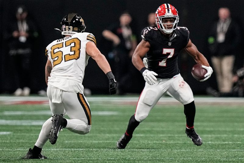 Atlanta Falcons running back Bijan Robinson (7) runs against New Orleans Saints linebacker Zack Baun (53) during the second half of an NFL football game, Sunday, Nov. 26, 2023, in Atlanta. (AP Photo/Brynn Anderson)