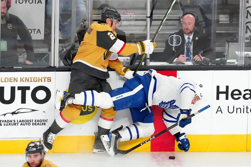 Feb 22, 2024; Las Vegas, Nevada, USA; Vegas Golden Knights defenseman Zach Whitecloud (2) checks Toronto Maple Leafs center John Tavares (91) during the first period at T-Mobile Arena. Mandatory Credit: Stephen R. Sylvanie-USA TODAY Sports