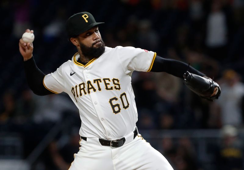 Sep 25, 2024; Pittsburgh, Pennsylvania, USA;  Pittsburgh Pirates relief pitcher Dennis Santana (60) pitches against the Milwaukee Brewers during the eighth inning at PNC Park. Mandatory Credit: Charles LeClaire-Imagn Images