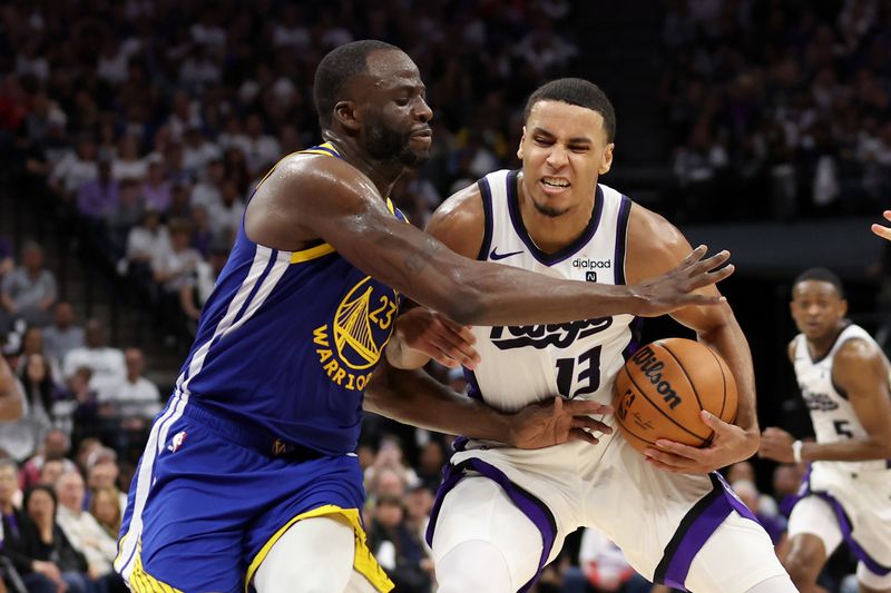 SACRAMENTO, CALIFORNIA - APRIL 16: Keegan Murray #13 of the Sacramento Kings is fouled by Draymond Green #23 of the Golden State Warriors in the second half during the Play-In Tournament at Golden 1 Center on April 16, 2024 in Sacramento, California.  NOTE TO USER: User expressly acknowledges and agrees that, by downloading and or using this photograph, User is consenting to the terms and conditions of the Getty Images License Agreement.  (Photo by Ezra Shaw/Getty Images)