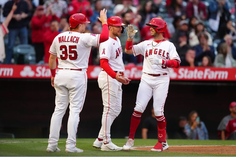 May 24, 2023; Anaheim, California, USA; Los Angeles Angels shortstop Zach Neto (9) celebrates with catcher Chad Wallach (35) and first baseman Brandon Drury (23) after hitting a three-run home run in the second inning against the Boston Red Sox at Angel Stadium. Mandatory Credit: Kirby Lee-USA TODAY Sports