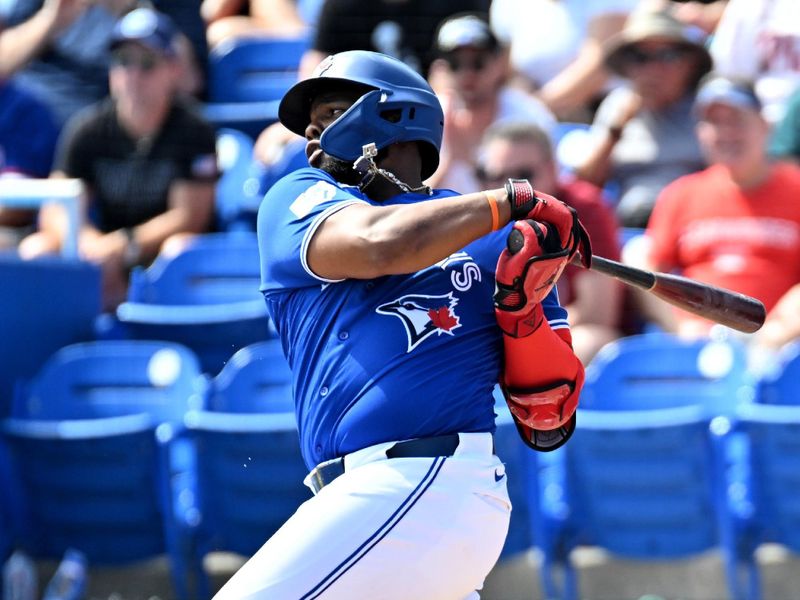 Feb 28, 2026; Dunedin, Florida, USA;  Toronto Blue Jays first baseman Vladimir Guerrero Jr. (27) hits a single in the first inning against the Philadelphia Phillies during spring training at TD Ballpark. Mandatory Credit: Jonathan Dyer-Imagn Images