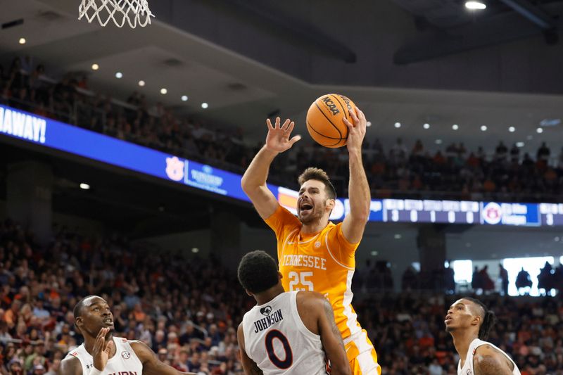 Mar 4, 2023; Auburn, Alabama, USA;  Tennessee Volunteers guard Santiago Vescovi (25) is fouled by Auburn Tigers guard K.D. Johnson (0) during the first half at Neville Arena. Mandatory Credit: John Reed-USA TODAY Sports