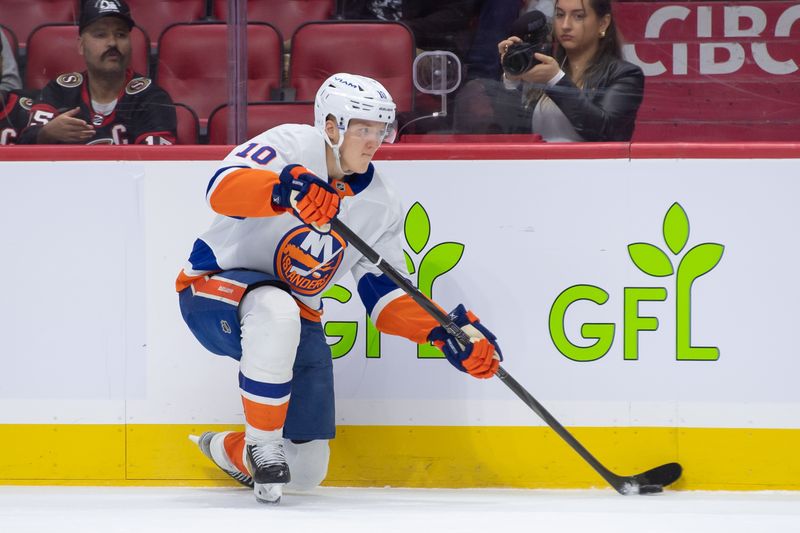 Dec 8, 2024; Ottawa, Ontario, CAN; New York Islanders right wing Simon Holmstrom (10) moves the puck in the first period against the  Ottawa Senators at the Canadian Tire Centre. Mandatory Credit: Marc DesRosiers-Imagn Images