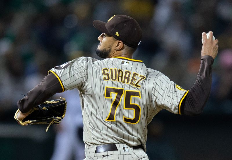 Sep 15, 2023; Oakland, California, USA; San Diego Padres pitcher Robert Suarez (75) delivers a pitch against the Oakland Athletics during the eighth inning at Oakland-Alameda County Coliseum. Mandatory Credit: D. Ross Cameron-USA TODAY Sports