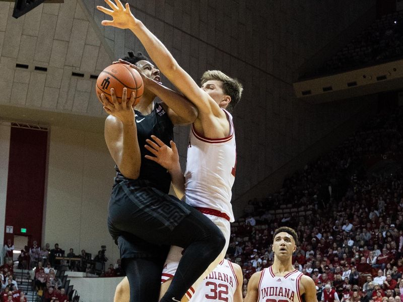 Jan 22, 2023; Bloomington, Indiana, USA; Michigan State Spartans guard A.J. Hoggard (11) shoots the ball while Indiana Hoosiers forward Miller Kopp (12) defends in the second half at Simon Skjodt Assembly Hall. Mandatory Credit: Trevor Ruszkowski-USA TODAY Sports