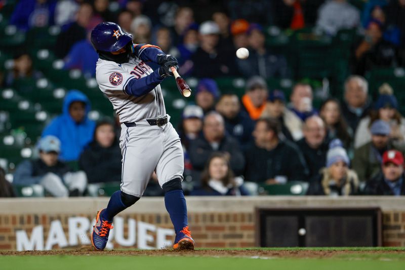 Apr 24, 2024; Chicago, Illinois, USA; Houston Astros second baseman Jose Altuve (27) hits a solo home run against the Chicago Cubs during the ninth inning at Wrigley Field. Mandatory Credit: Kamil Krzaczynski-USA TODAY Sports