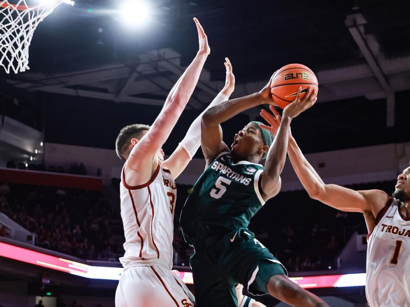 Feb 1, 2025; Los Angeles, California, USA;  Michigan State Spartans guard Tre Holloman (5) shoots the ball against the USC Trojans at Galen Center. Mandatory Credit: William Navarro-Imagn Images
