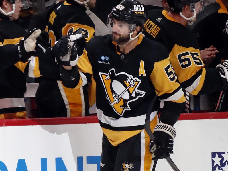 Feb 25, 2024; Pittsburgh, Pennsylvania, USA;  Pittsburgh Penguins defenseman Kris Letang (58) celebrates his goal with the Pens bench against the Philadelphia Flyers during the third period at PPG Paints Arena. Pittsburgh won 7-6. Mandatory Credit: Charles LeClaire-USA TODAY Sports