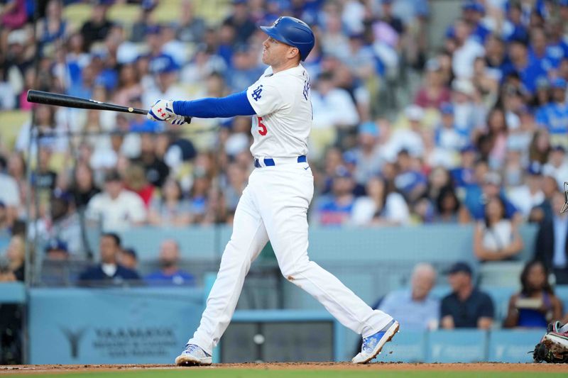 Jul 3, 2024; Los Angeles, California, USA; Los Angeles Dodgers first baseman Freddie Freeman (5) hits a three-run home run in the first inning against the Arizona Diamondbacks at Dodger Stadium. Mandatory Credit: Kirby Lee-USA TODAY Sports