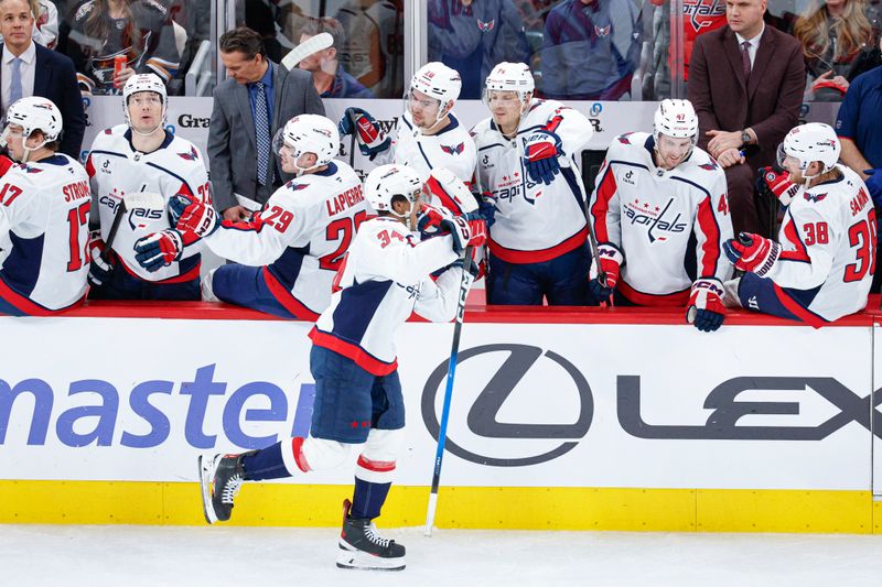 Jan 9, 2026; Chicago, Illinois, USA; Washington Capitals right wing Justin Sourdif (34) celebrates with teammates after scoring against the Chicago Blackhawks during the second period at United Center. Mandatory Credit: Kamil Krzaczynski-Imagn Images