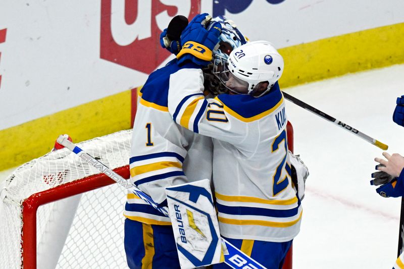 Oct 19, 2024; Chicago, Illinois, USA;  Buffalo Sabres goaltender Ukko-Pekka Luukkonen (1) and center Jiri Kulich (20) hug after the third period against the Chicago Blackhawks at the United Center. Mandatory Credit: Matt Marton-Imagn Images