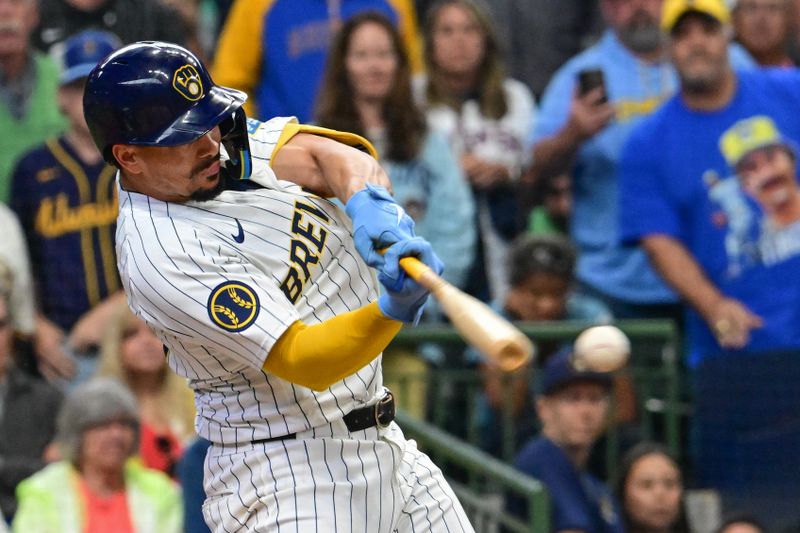 Jun 1, 2024; Milwaukee, Wisconsin, USA; Milwaukee Brewers shortstop Willy Adames (27) hits a single to drive in the winning run in the tenth inning against the Chicago White Sox at American Family Field. Mandatory Credit: Benny Sieu-USA TODAY Sports