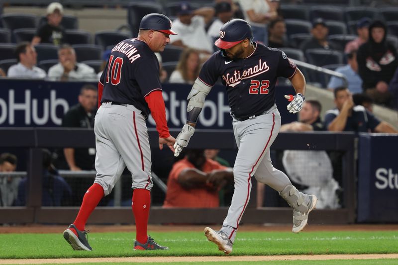 Aug 23, 2023; Bronx, New York, USA; Washington Nationals first baseman Dominic Smith (22) celebrates his solo home run with third base coach Gary Disarcina (10) during the ninth inning against the New York Yankees at Yankee Stadium. Mandatory Credit: Vincent Carchietta-USA TODAY Sports