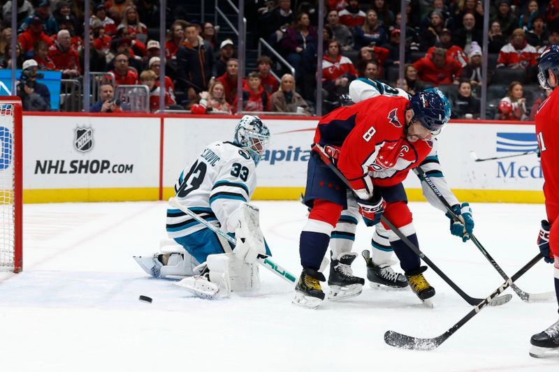 Jan 15, 2026; Washington, District of Columbia, USA; Washington Capitals left wing Alex Ovechkin (8) attempts to deflect a shot on San Jose Sharks goaltender Alex Nedeljkovic (33) in the final seconds during the third period at Capital One Arena. Mandatory Credit: Geoff Burke-Imagn Images