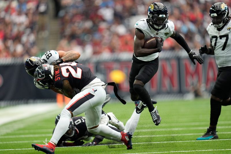 Jacksonville Jaguars wide receiver Brian Thomas Jr., right, runs past Houston Texans cornerback Derek Stingley Jr. (24) during the second half of an NFL football game, Sunday, Sept. 29, 2024, in Houston. (AP Photo/Eric Gay)