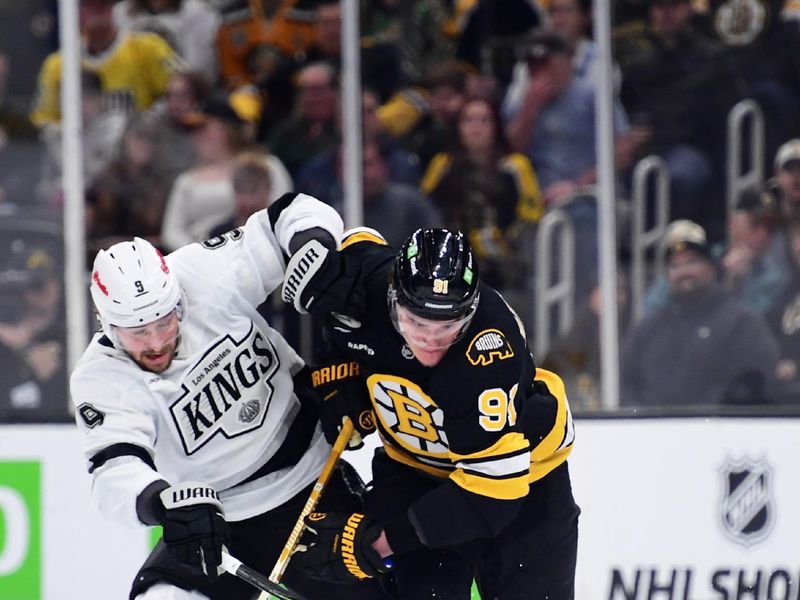 Mar 10, 2026; Boston, Massachusetts, USA;  Los Angeles Kings right wing Adrian Kempe (9) and Boston Bruins defenseman Nikita Zadorov (91) battle for the puck during the first period at TD Garden. Mandatory Credit: Bob DeChiara-Imagn Images