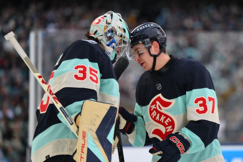 Jan 1, 2024; Seattle, Washington, USA; Seattle Kraken goaltender Joey Daccord (35) and center Yanni Gourde (37) celebrate after defeating the Vegas Golden Knights in the 2024 Winter Classic ice hockey game at T-Mobile Park. Mandatory Credit: Steven Bisig-USA TODAY Sports