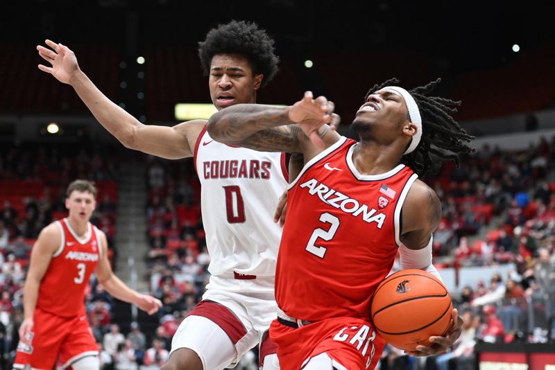 Jan 13, 2024; Pullman, Washington, USA; Arizona Wildcats guard Caleb Love (2) is fouled on the drive by Washington State Cougars forward Jaylen Wells (0) in the second half at Friel Court at Beasley Coliseum. Washington State won 73-70. Mandatory Credit: James Snook-USA TODAY Sports