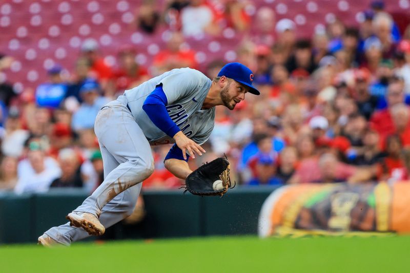 Jul 29, 2024; Cincinnati, Ohio, USA; Chicago Cubs first baseman Michael Busch (29) grounds the ball hit by Cincinnati Reds designated hitter Jeimer Candelario (not pictured) in the third inning at Great American Ball Park. Mandatory Credit: Katie Stratman-USA TODAY Sports