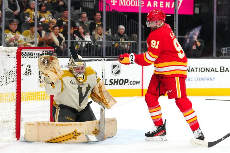 Jan 13, 2024; Las Vegas, Nevada, USA; Calgary Flames center Nazem Kadri (91) attempts to deflect a shot towards Vegas Golden Knights goaltender Logan Thompson (36) during the first period at T-Mobile Arena. Mandatory Credit: Stephen R. Sylvanie-USA TODAY Sports