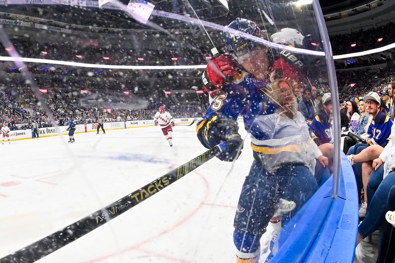 Apr 12, 2024; St. Louis, Missouri, USA;  St. Louis Blues defenseman Tyler Tucker (75) checks Carolina Hurricanes defenseman Dmitry Orlov (7) during the third period at Enterprise Center. Mandatory Credit: Jeff Curry-USA TODAY Sports