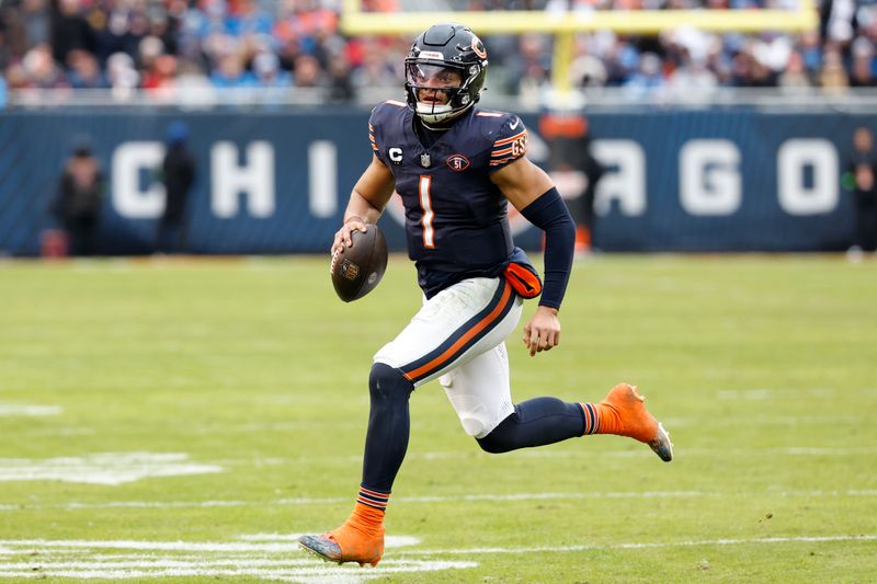 Chicago Bears quarterback Justin Fields (1) runs with the ball to score a touchdown against the Detroit Lions during the second half of an NFL football game, Sunday, Dec. 10, 2023, in Chicago. (AP Photo/Kamil Krzaczynski)