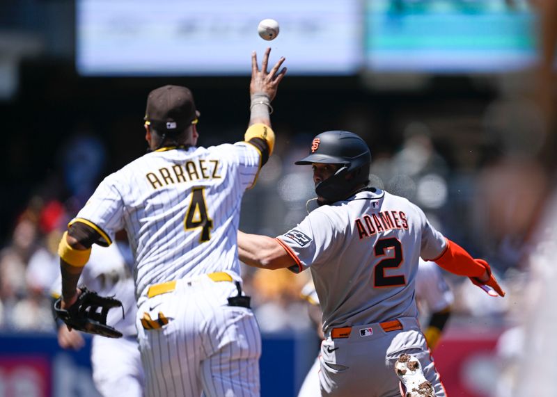 Apr 30, 2025; San Diego, California, USA; San Francisco Giants shortstop Willy Adames (2) is caught in a rundown by San Diego Padres first baseman Luis Arraez (4) during the first inning at Petco Park. Adames was out on the play. Mandatory Credit: Denis Poroy-Imagn Images