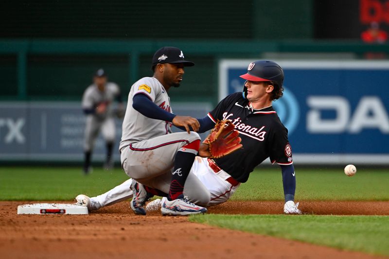 May 22, 2025; Washington, District of Columbia, USA; Washington Nationals outfielder Robert Hassell III (57) steals second beating the tag by Atlanta Braves second baseman Ozzie Albies (1) at Nationals Park. Mandatory Credit: Brad Mills-Imagn Images