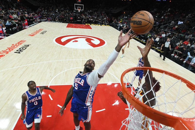 ATLANTA, GA - OCTOBER 14: Andre Drummond #5 of the Philadelphia 76ers goes for rebound against the Atlanta Hawks  during a preseason game on October 14, 2024 at State Farm Arena in Atlanta, Georgia.  NOTE TO USER: User expressly acknowledges and agrees that, by downloading and/or using this Photograph, user is consenting to the terms and conditions of the Getty Images License Agreement. Mandatory Copyright Notice: Copyright 2024 NBAE (Photo by Adam Hagy/NBAE via Getty Images)