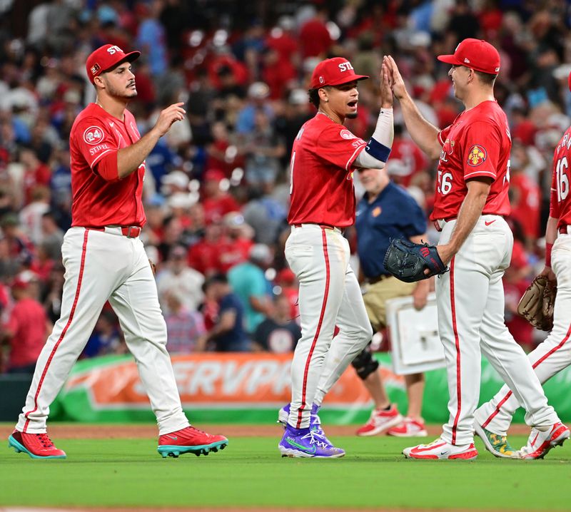 Aug 17, 2024; St. Louis, Missouri, USA;  St. Louis Cardinals third base Nolan Arenado (28) and shortstop Masyn Winn (0) greet St. Louis Cardinals pitcher Ryan Helsley (56, right) after Helsley pitched in relief in the ninth inning against the Los Angeles Dodgers at Busch Stadium. Mandatory Credit: Tim Vizer-USA TODAY Sports