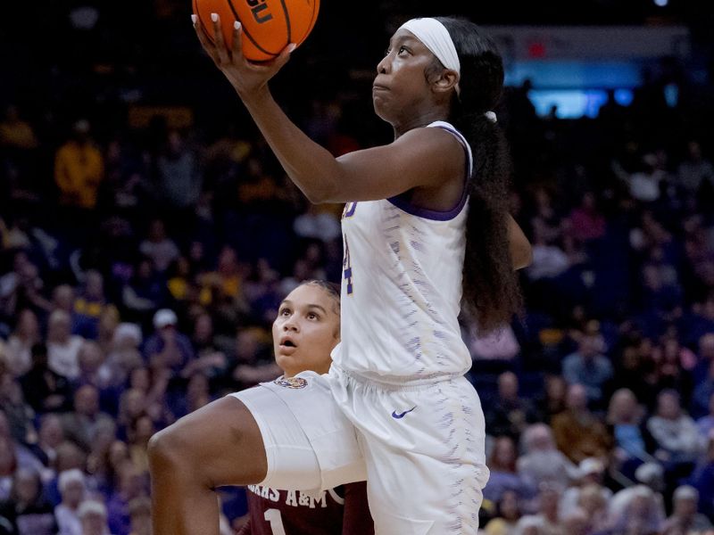 Jan 11, 2024; Baton Rouge, Louisiana, USA; LSU Lady Tigers guard Flau'jae Johnson (4) goes up for a lay-up against Texas A&M Aggies guard Endyia Rogers (1) during the second half at Pete Maravich Assembly Center. Mandatory Credit: Matthew Hinton-USA TODAY Sports