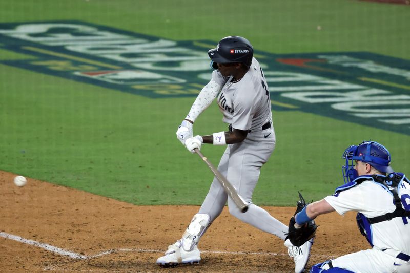 Oct 25, 2024; Los Angeles, California, USA; New York Yankees third baseman Jazz Chisholm Jr. (13) hits a single against the Los Angeles Dodgers in the tenth inning during game one of the 2024 MLB World Series at Dodger Stadium. Mandatory Credit: Kiyoshi Mio-Imagn Images