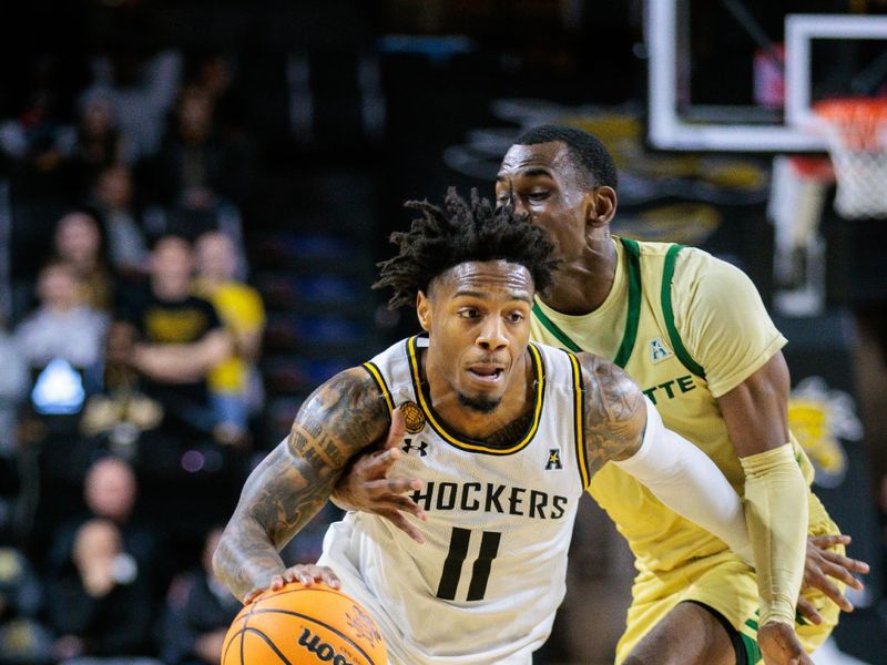 Jan 14, 2025; Wichita, Kansas, USA; Wichita State Shockers guard Justin Hill (11) brings the ball up court during the second half against the Charlotte 49ers at Charles Koch Arena. Mandatory Credit: William Purnell-Imagn Images