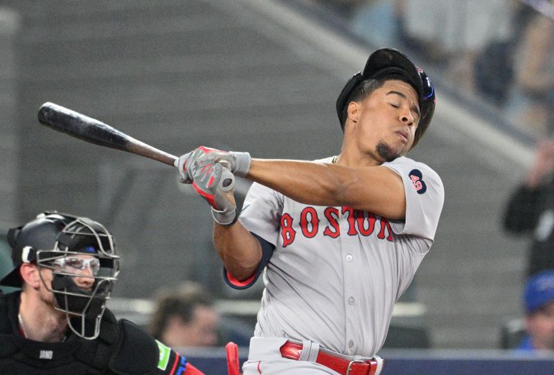 Jun 17, 2024; Toronto, Ontario, CAN;  Boston Red Sox second baseman Enmanuel Valdez (47) loses his batting helmet on a swinging strike against the Toronto Blue Jays in the seventh inning at Rogers Centre. Mandatory Credit: Dan Hamilton-USA TODAY Sports